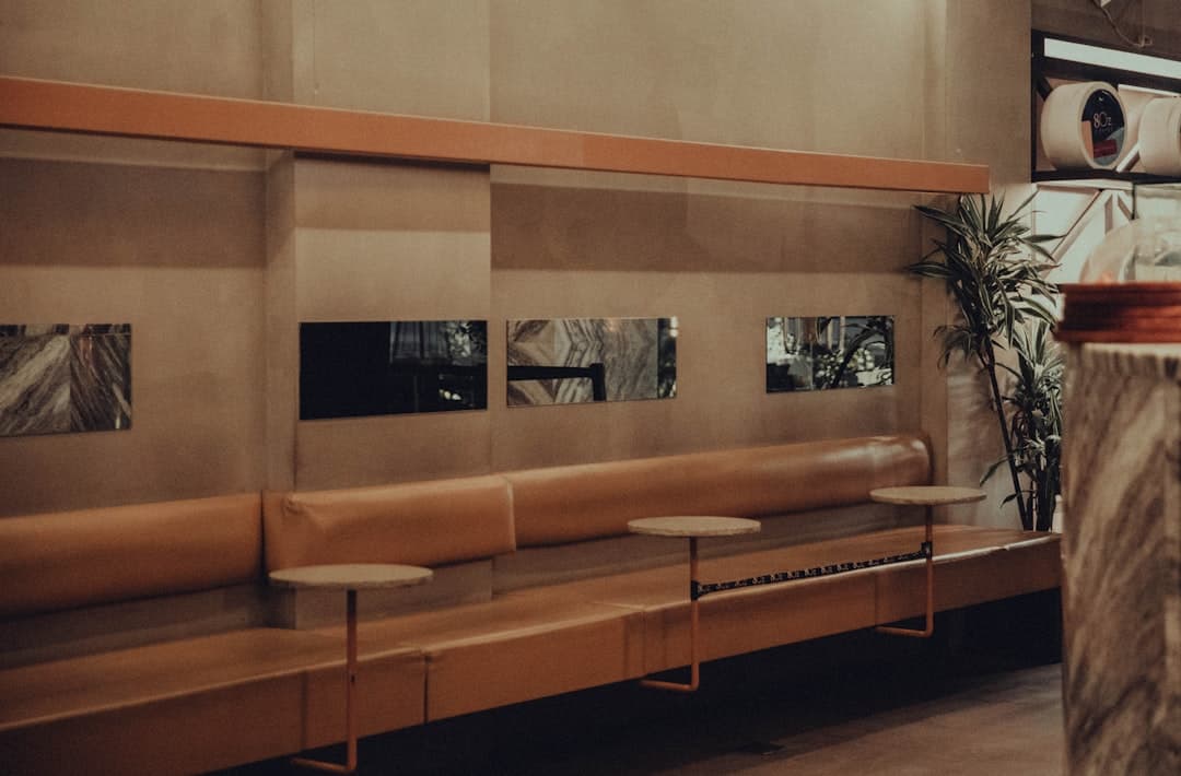 Inside a venue with booth seating and high tables